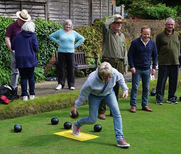 A group of people playing bowls