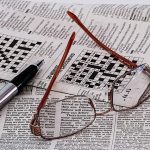 Crossword, pen, and glasses