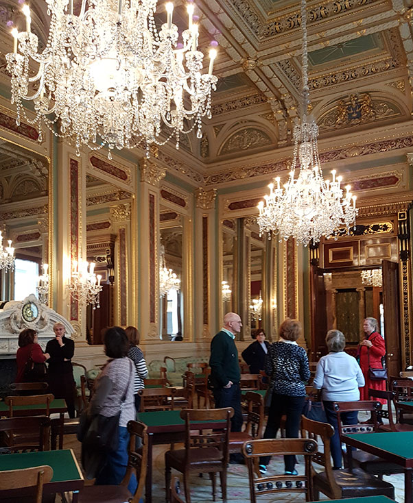 Room with chandeliers, mirrors, and gilt decorations