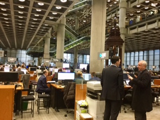 Interior view of Lloyd's of London with underwriters at desks