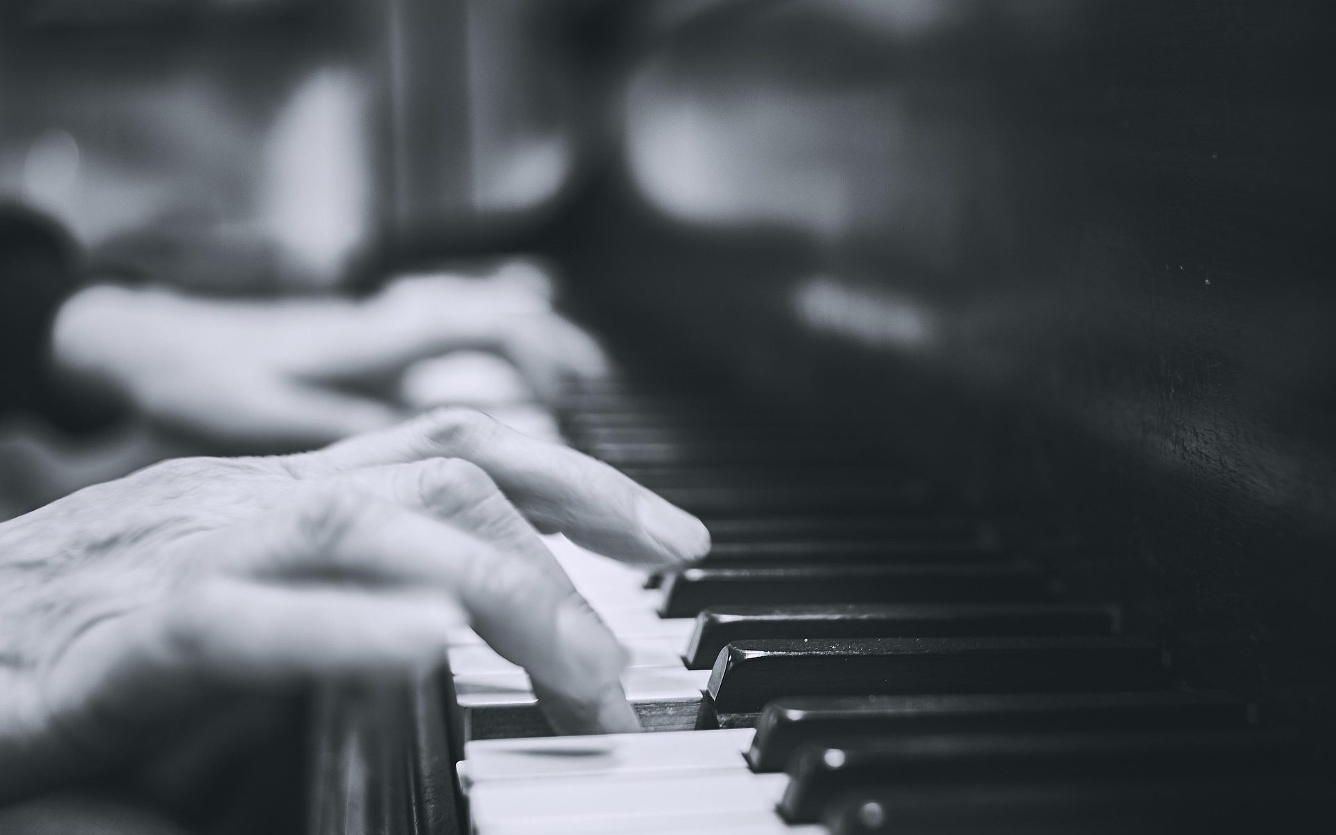 Hands on piano keyboard