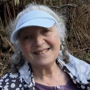 Woman with grey hair and eye shade